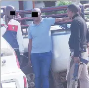  ?? (Pic: Sibusiso Shange) ?? An armed police officer keeping an eye on the men who allegedly lured the two South African businessme­n to engage in a bogus E4 million deal.