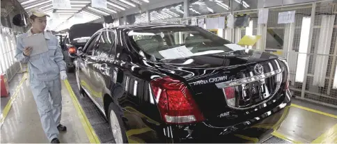  ??  ?? Checking on newly produced cars at a Toyota factory in Tianjin. — Reuters photo