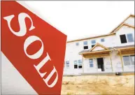  ?? Associated Press ?? A sold sign stands in front of a home under constructi­on in West Des Moines, Iowa.