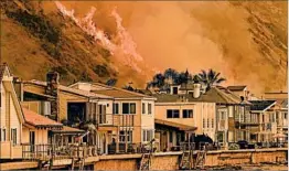  ?? WALLY SKALIJ/LOS ANGELES TIMES ?? Wildfires reached State Route 101 on Wednesday north of Ventura, threatenin­g beachfront homes. This particular fire started Monday afternoon about 30 miles inland.