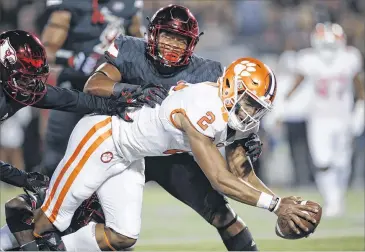  ?? JOE ROBBINS / GETTY IMAGES ?? Clemson quarterbac­k Kelly Bryant reaches across the goal line for one of his two touchdowns rushing against Louisville. Bryant outplayed Lamar Jackson, the Cardinals’ Heisman Trophy winner.