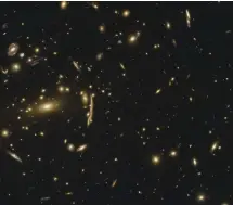  ??  ?? LEFT Distorted light from distant galaxy clusters can be used to detect invisible dark matter subhalos, which appear to be more compact than predicted