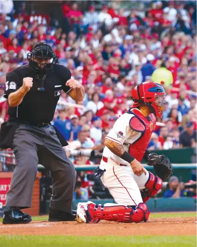  ??  ?? Cubs rookie Kris Bryant grimaces after striking out to end the first inning Saturday against the Cardinals. Bryant is hitless in three postseas on games, but he hasn’t let that affect his fielding.