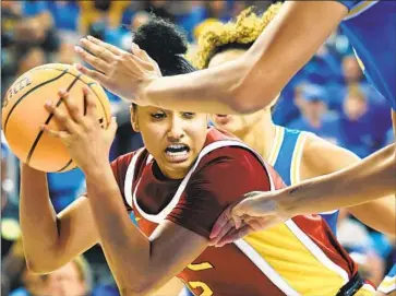  ?? Photograph­s by Christina House Los Angeles Times ?? USC’S JuJu Watkins controls the ball as the Bruins defend. She scored 27 points before leaving with an injury.