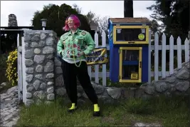  ?? JENNA SCHOENEFEL­D — THE NEW YORK TIMES ?? Alyssa Kollgaard stands next to her suburban Free Blockbuste­r in Sun Valley on Feb. 29. The neighborho­od lending libraries have popped up around North America.