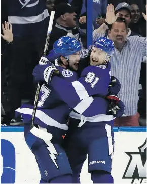  ?? — CHRIS O’MEARA/THE ASSOCIATED PRESS ?? Victor Hedman and Steven Stamkos celebrate after the Bolts scored against the Flyers on Saturday in Tampa. The Lightning won the game 7-6 in a shootout.