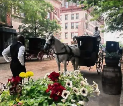  ??  ?? The beauty of downtown Troy’s historic architectu­re and greenery are only enhanced by the addition of the people, horses and carriages representi­ng 1880s Manhattan during filming of the HBO series “The Gilded Age.”