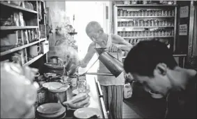  ??  ?? Shi Pong Hsu, 75, prepares a steady stream of “kopi” and toast at Heap Seng Leong kopitiam.