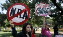  ?? GETTY IMAGES ?? NO MORE SHOOTINGS: Protesters hold signs Tuesday in the wake of mass shootings in Texas and Ohio.