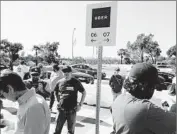  ?? Chris Erskine Los Angeles Times ?? USERS OF UBER service congregate at Lot 12 at Dodger Stadium to be picked up after a game.