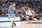  ?? DAVID BERDING/USA TODAY SPORTS ?? Minnesota Timberwolv­es forward Jaden Mcdaniels drives to the basket against Memphis Grizzlies center Jon Teske.