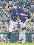  ?? AFP ?? The Twins’ Ehire Adrianza, left, celebrates after hitting a grand slam.