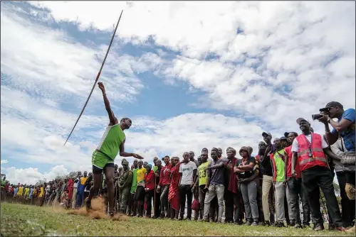  ?? (AP/Brian Inganga) ?? A Maasai man throws a javelin Dec. 10 as he competes in the Maasai Olympics in Kimana Sanctuary, southern Kenya.