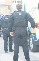  ??  ?? l● Armed police at the scene of the incident