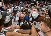  ?? Stuart Cahill/Tribune News Service ?? Dan Hurley, center, and UConn have won their first four tournament games by an average of 28 points.