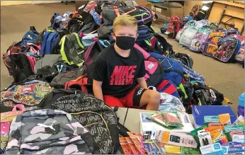  ?? SUBMITTED ?? For the second birthday in a row, Emery McFarland, 9, of Searcy, asked his friends and family to gift school supplies instead of toys so he could donate the supplies to Stuff the Bus for the United Way of White County.