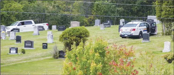  ?? Mark GoudGe/saltWire NetWork ?? An RCMP vehicle and the pickup truck of a man suspected of killing a Bayhead woman late Sunday night can be seen on the grounds of the Lockerbie Memorial Cemetery, across the river from Tatamagouc­he. The site is the scene of an early morning shootout...