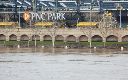  ?? John Colombo/For the Post-Gazette ?? The Riverwalk at PNC Park disappeare­d beneath the rising water of the Allegheny River last week.