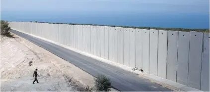  ?? SEBASTIAN SCHEINER, AP ?? An Israeli soldier stands near a wall at the Israel Lebanon border near Rosh Haniqra in northern Israel.