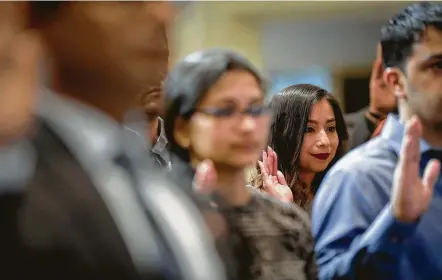  ?? Jon Shapley / Staff photograph­er ?? Miriam Arellano smiles as she finishes the Oath of Allegiance during a naturaliza­tion ceremony Wednesday at City Hall. Arellano was brought from Mexico as an undocument­ed immigrant when she was younger than 2 years old.
