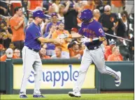  ?? Patrick Semansky / Associated Press ?? Mets catcher Kevin Plawecki, right, rounds the bases past Glenn Sherlock after hitting a grand slam in the sixth inning Wednesday against the Orioles.