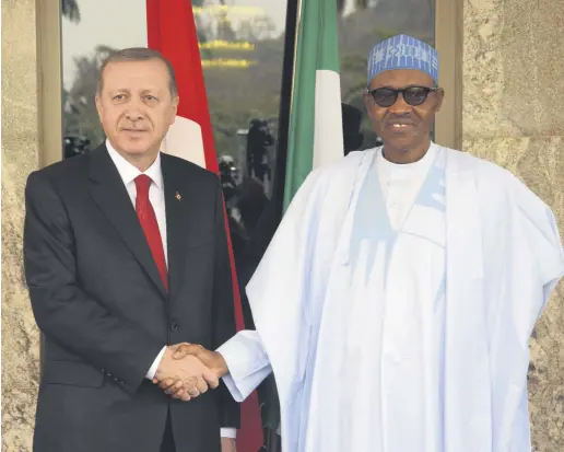  ?? ?? President Recep Tayyip Erdoğan (L) is welcomed by Nigeria’s President Muhammadu Buhari, during an official visit in Abuja, Nigeria, March 2, 2016.