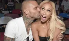  ??  ?? Matt Polinksy, a WWE wrestling commentato­r known as Corey Graves, and his girlfriend, Leah Van Dale, who wrestles under the name Carmella, have made Pittsburgh their home.