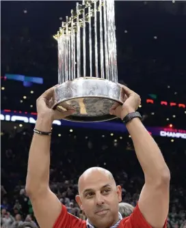  ?? CHRISTOPHE­R EVANS / HERALD STAFF FILE ?? CHAMPS: Red Sox manager Alex Cora holds up the World Series trophy as the team was honored by the Boston Celtics during a basketball game at TD Garden on Nov. 1. Below, President Trump, second from left, and Defense Secretary Jim Mattis, second from right, attend the annual Army-Navy football game at Lincoln Financial Field in Philadelph­ia, Pa., yesterday. Trump officiated the coin toss.