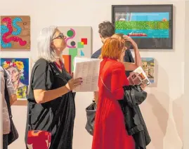  ?? Picture / Michael McKeagg ?? Niki Vernon taking in the art at the opening of the 2020 pattillo Whanganui Arts Review.