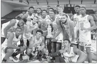  ?? AP/SCOTT AUDETTE ?? Maryland players pose with the Orlando Invitation­al trophy after defeating Marquette in the championsh­ip game of the Orlando Invitation­al on Sunday in Lake Buena Vista, Fla.