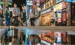  ?? KIICHIRO SATO/AP 2021 ?? Bars and restaurant­s line a street in Tokyo’s Shibuya district. The expected reopening of Japan as COVID-19 curbs are lifted should provide a boost to the economy.
