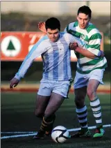  ??  ?? Camp United’s James Crean holds off Pa McGrath, Killarney Celtic, in the 2013 Greyhound Bar Cup at Celtic Park, Killarney