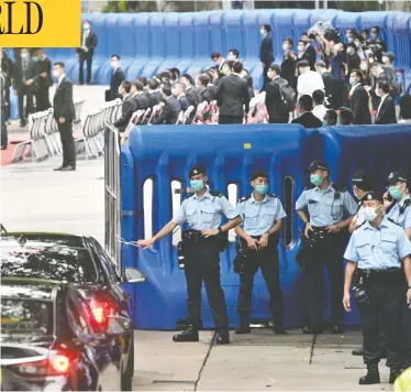  ?? ANTHONY WALLACE / AFP VIA GETTY IMAGES ?? Guests drive past the Office for Safeguardi­ng National Security of the Central People’s Government in Hong Kong after its inaugurati­on on Wednesday. The new office allows Chinese security agents to operate in the former British colony.