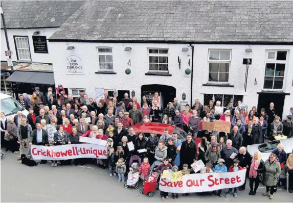  ??  ?? > Around 150 people turned out in Crickhowel­l High Street for this protest to oppose plans to convert the pub into a convenienc­e store