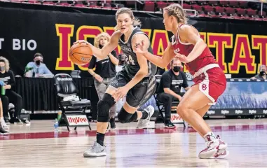  ??  ?? Iowa State junior Ashley Joens drives to the basket during the Cyclones' 64-63 win against Gabby Gregory (right) and OU on Tuesday night in Ames, Iowa. [LUKE LU/IOWA STATE ATHLETICS]