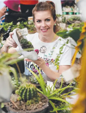  ?? Picture: STEWART McLEAN ?? GREEN SCENE: Lara Ratcliffe was selling her handmade concrete pots at the Cairns Local Market, which raised money for Australian farmers.