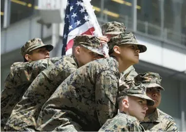  ?? JOHN J. KIM/CHICAGO TRIBUNE ?? JROTC cadets mimic the famous WWII photograph, “Raising the Flag on Iwo Jima,” during Chicago’s Memorial Day parade Saturday.