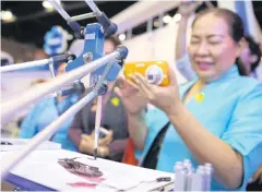  ??  ?? Bi-Robot Touch, developed by Kasetsart University, shows painting skills at Thailand Research Expo last year.