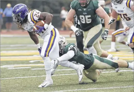  ?? Jim Agnew / Special to the times union ?? ualbany running back elijah ibitokun-hanks drags a defender for some of his 221 rushing yards against William &amp; mary on Saturday. despite the prolific attack, the danes went three-and-out to give the tribe a final possession.