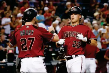  ?? ASSOCIATED PRESS ?? ARIZONA DIAMONDBAC­KS’ JAKE LAMB (22) CELEBRATES Drury (27) during the fifth inning Wednesday in Phoenix. his two-run home run against the Chicago White Sox with Brandon