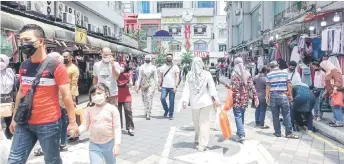  ?? — Bernama photo ?? People are seen shopping at a shopping district in Kuala Lumpur. Population projection­s from 2010 to 2040 by the DOSM revealed Malaysia may become an ageing nation by 2030 with people aged 60 years and over surpassing 15 per cent of the population and the situation is a cause for concern as it could affect the country’s labour force and economy at large.