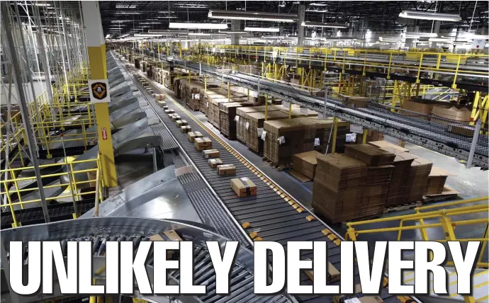  ?? AP FILE ?? ‘SMALL RISK’: Packages zip along a conveyor system at Amazon’s fulfillmen­t center in Baltimore. Specialist­s say the likelihood of a package sent directly from China to deliver coronaviru­s locally is slim to none. Below, a security guard checks the temperatur­es of shoppers waiting to enter a mall in Beijing.