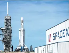  ?? JIM WATSON/GETTY IMAGES ?? The SpaceX Falcon Heavy rests on a launch pad at the Kennedy Space Center in Florida ahead of its launch on Tuesday.