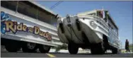  ?? THE ASSOCIATED PRESS ?? A man looks at an idled duck boat in the parking lot of Ride the Ducks on Saturday in Branson, Mo. One of the company’s duck boats capsized Thursday night resulting in several deaths on Table Rock Lake.