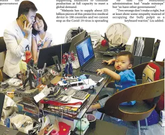  ??  ?? Lin at his desk while his daughter Hui Wen, five, and son Yi Herng, two, keep him company. – PIX COURTESY OF LIN LAY GENG