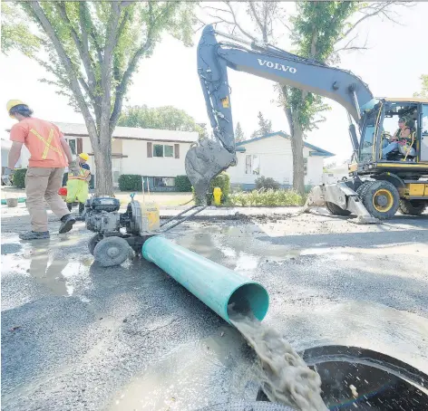  ?? MICHAEL BELL ?? City crews were hard at work on Friday repairing a water main on Nagel Crescent. Forty lines have been fixed so far this month.