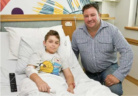  ??  ?? HOSPITAL STAY: Young patient Blair Cary, 11, with Cambooya Campdraft Associatio­n president Neil Kann in the St Gabriel’s Unit at St Vincent’s Private Hospital, which the associatio­n has donated $10,000 to. PHOTO: NEV MADSEN