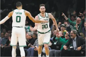  ?? Michael Dwyer / Associated Press ?? The Celtics’ Gordon Hayward (20), back following 10 months of rehab after ankle surgery from a gruesome injury in last season’s opener, celebrates his three-pointer with Jayson Tatum during the second half against the 76ers.