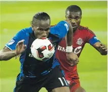  ?? THE CANADIAN PRESS ?? Didier Drogba, left, in action against TFC defender Ashtone Morgan June 1, is a big reason why Montreal has something to play for tonight in the second leg of the Amway Canadian Championsh­ip.