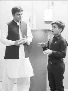  ??  ?? Hammad (right) attends an English language class at a languages academy in Peshawar.